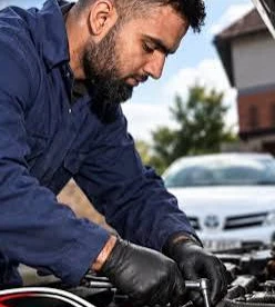 Kamron Ali working under the bonnet of a car